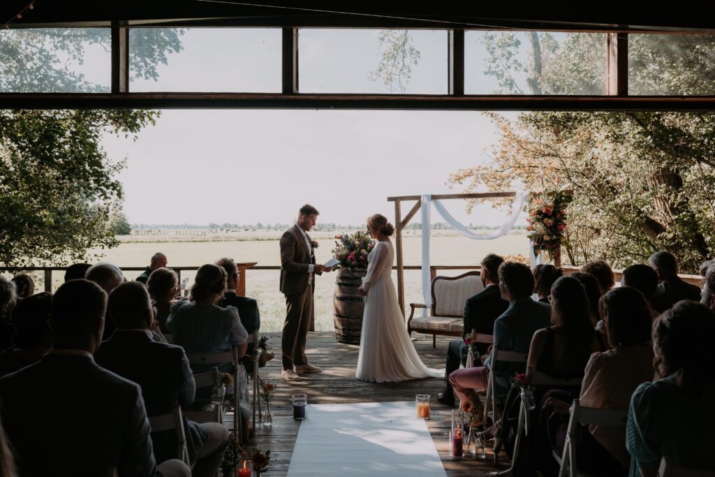 Bruidpaar staat tegenover elkaar en leest geloften voor